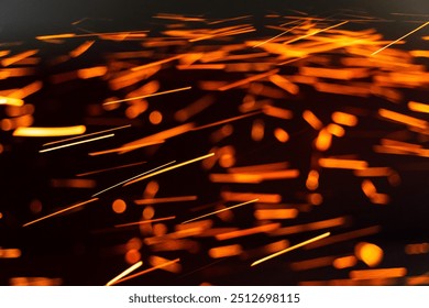 Sparks fly in the dark during metalwork. Bright sparks illuminate the darkness as metalworkers create new tools - Powered by Shutterstock