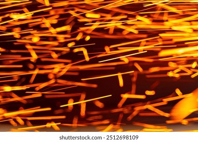 Sparks flying during metalworking process at a workshop. Bright sparks illuminate the workshop as metal is shaped - Powered by Shutterstock