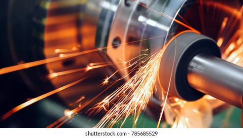 sparks flying while machine griding and finishing metal - Shutterstock ID 785685529