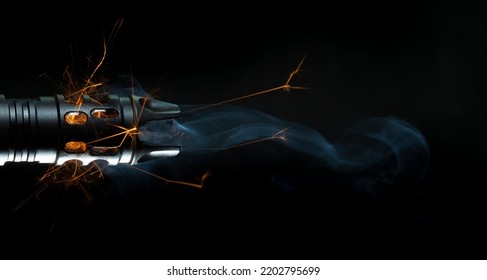 Sparks And Smoke Coming Out Of A Gun Barrel On A Black Background