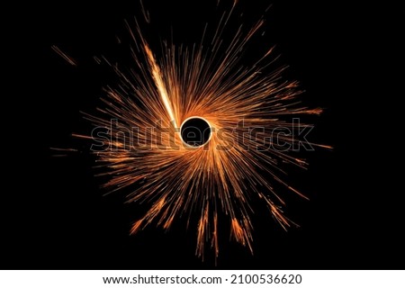 Sparks from steel wool on a background of the night sky. Long exposure.