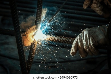 Sparks from welding, Arc welding. Welding of two metal plates in inert gases. MIG  MAG. A bright flash of light and a sheaf of sparks. - Powered by Shutterstock