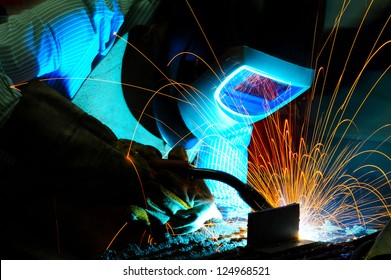 sparks while welder uses torch to welding - Powered by Shutterstock