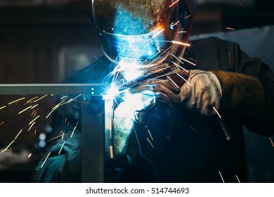 sparks while welder uses torch to welding
