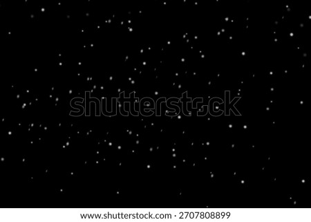 Sparse light snow overlay with tiny bright flakes gently falling across deep black night sky, subtle winter snowfall background texture for minimalist Christmas designs and soft cinematic scenes

