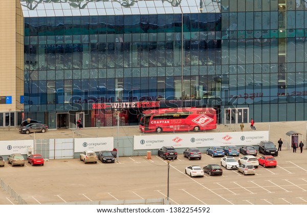 Spartak Football Club red bus near Spartak\
Stadium. Moscow. Russia 04/2019. football team has arrived for\
match or training session. Red white store. Advertising Bank\
Otkritie Financial\
Corporation.