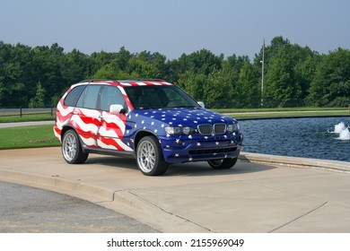 SPARTANBURG, UNITED STATES - Aug 03, 2006: A 2006 BMW X5 Car Painted In The American Flag Parked On A Curb Outside The Manufacturing Plant