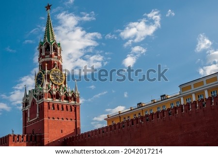 Spasskaya Tower of the Moscow Kremlin. Moscow chimes against the background of a blue sky with clouds.