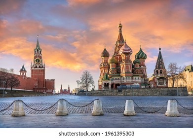 Spasskaya Tower Of The Moscow Kremlin And St. Basil's Cathedral Under Red Sunset Clouds In Moscow On A Sunny Spring Evening
