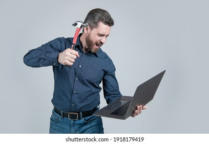 Spate of cyberattack. Hacker assaulting computer with hammer. Targeted cyberattack. Cyberthreat. Breaching information system. Cybercrime. Hacking attack.