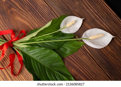 Spathiphyllum On The Wooden Desk