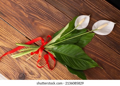 Spathiphyllum On The Wooden Desk