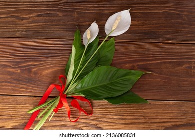 Spathiphyllum On The Wooden Desk