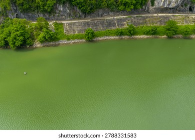 The spatial scale of a wide river is captured from a high altitude drone perspective. The vastness of the water and land demonstrates the grandeur of the remote tropical river valley.