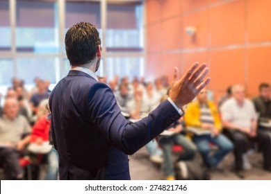 Speaker At Business Conference With Public Presentations. Audience At The Conference Hall. Entrepreneurship Club. Rear View. Horisontal Composition. Background Blur.