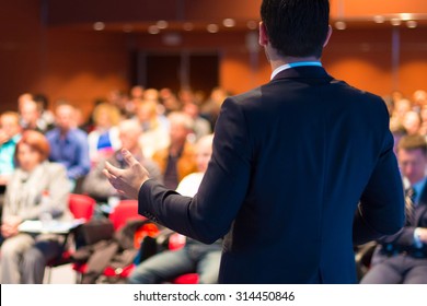 Speaker at Business Conference with Public Presentations. Audience at the conference hall. Entrepreneurship club. Rear view. Horisontal composition. Background blur. - Shutterstock ID 314450846