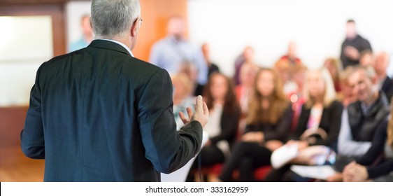 Speaker At Business Conference With Public Presentations. Audience At The Conference Hall. Entrepreneurship Club. Rear View. Horisontal Composition. Background Blur.