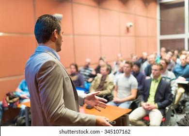 Speaker At Business Conference With Public Presentations. Audience At The Conference Hall. Business And Entrepreneurship Concept. Background Blur. Shallow Depth Of Field.