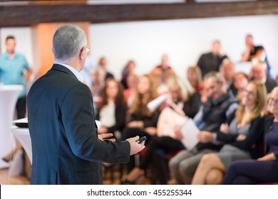 Speaker At Business Conference With Public Presentations. Audience At The Conference Hall. Entrepreneurship Club. Rear View. Horisontal Composition. Background Blur.