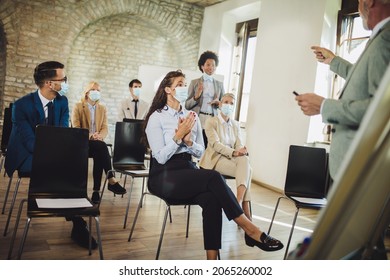 Speaker At Business Workshop And Presentation. Audience With Protective Mask At The Conference Room.