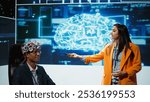 Speaker does EEG headset presentation during tech convention, demonstrating successful implementation of AI in driving forward startup businesses, sharing latest neuroscience discoveries, camera B