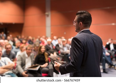 Speaker Giving Talk At Business Conference Event. Audience At Conference Hall. Business And Entrepreneurship Concept.