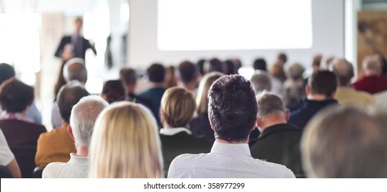 Speaker Giving a Talk at Business Meeting. Audience in the conference hall. Business and Entrepreneurship. Panoramic composition suitable for banners. - Shutterstock ID 358977299