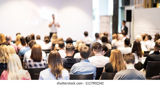 Speaker giving a talk in conference hall at business event. Audience at the conference hall. Business and Entrepreneurship concept. Focus on unrecognizable people in audience. - Shutterstock ID 1117902242
