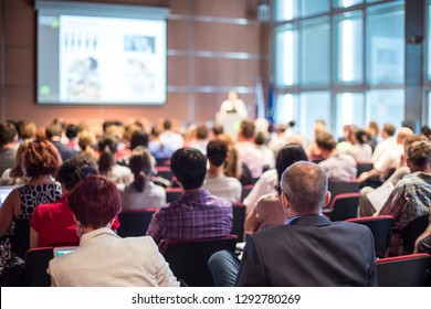 Speaker giving a talk in conference hall at business event. Audience at the conference hall. Business and Entrepreneurship concept. Focus on unrecognizable people in audience. - Shutterstock ID 1292780269