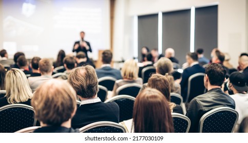 Speaker giving a talk in conference hall at business event. Rear view of unrecognizable people in audience at the conference hall. Business and entrepreneurship concept. - Shutterstock ID 2177030109