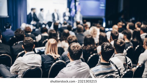 Speaker giving a talk in conference hall at business event. Rear view of unrecognizable people in audience at the conference hall. Business and entrepreneurship concept - Shutterstock ID 2321303215