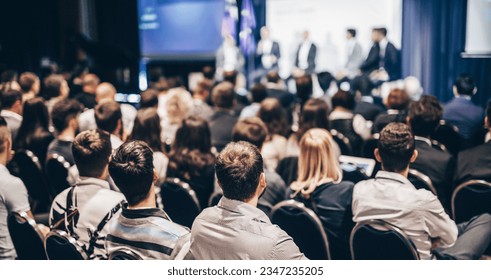 Speaker giving a talk in conference hall at business event. Rear view of unrecognizable people in audience at the conference hall. Business and entrepreneurship concept - Shutterstock ID 2347235205