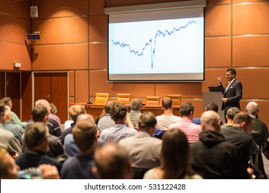 Speaker Giving A Talk In Conference Hall At Business Event. Audience At The Conference Hall. Business And Entrepreneurship Concept.