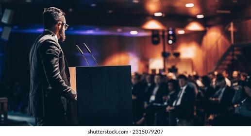 Speaker giving a talk on corporate business conference. Unrecognizable people in audience at conference hall. Business and Entrepreneurship event. - Shutterstock ID 2315079207