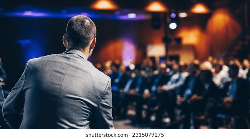 Speaker giving a talk on corporate business conference. Unrecognizable people in audience at conference hall. Business and Entrepreneurship event. - Shutterstock ID 2315079275