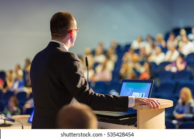 Speaker Giving A Talk On Corporate Business Conference. Audience At The Conference Hall. Business And Entrepreneurship Event.