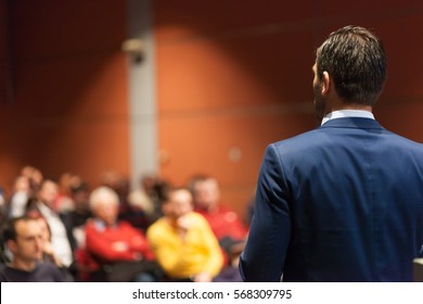 Speaker Giving A Talk On Corporate Business Conference. Audience At The Conference Hall. Business And Entrepreneurship Event.