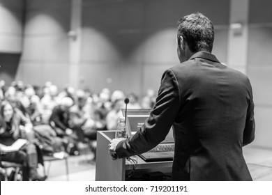 Speaker Giving A Talk On Corporate Business Conference. Audience At The Conference Hall. Business And Entrepreneurship Event. Black And White Image.