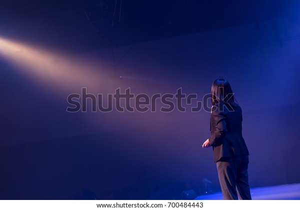 Speaker On Stage Giving Talk Business Stock Photo (Edit Now) 700484443