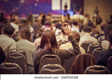 Speaker on the stage with Rear view of Audience in put hand up acton for question in the meeting or seminar meeting, business and education concept - Powered by Shutterstock