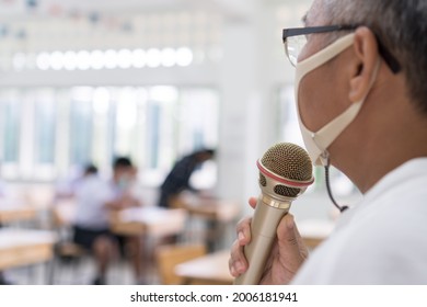 Speaker Professor Female Asian Teaching Explain Wear Medical Face Mask For Safety Speaking Microphone At Whiteboard In Classroom In University. Teacher In Health Care Prevent COVID-19 Disease Epidemic