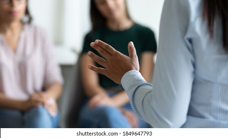 Speaker talking. Close up of unknown young woman business leader trainer lecturer coach speaking on briefing seminar training conference meeting with audience of colleagues partners investors students - Shutterstock ID 1849647793
