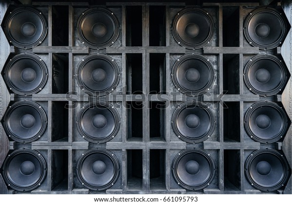 Speakers collage, useful image in a\
musical composition. Wall of large black music\
speakers.