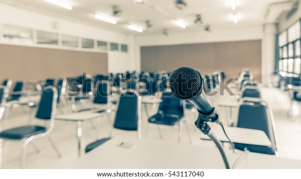 Speaker\'s\
microphone in educational event, conference lecture hall or seminar\
meeting room with audience or school\
student