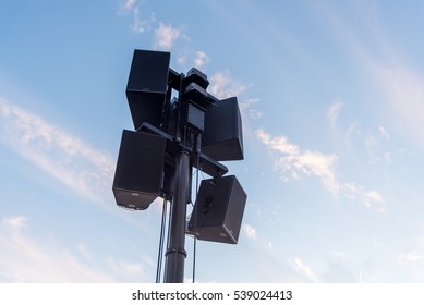 Speakers on the Pole with Blue Sky Background