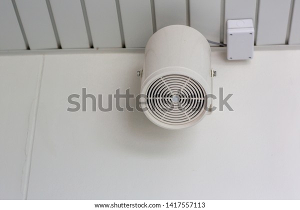 Speakers on a wall of building .Loud\
speaker in factory. Pair of loudspeaker on the wall of car park\
building,broadcasting technology. Public address\
system.