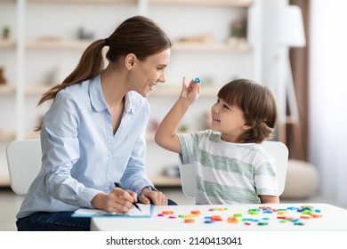 Speaking classes for kids. Cute little boy showing and pronouncing sound O with his teacher, exercising together at classroom, free space - Shutterstock ID 2140413041