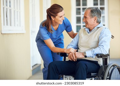 Speaking, happy caregiver or old man in wheelchair in hospital helping an elderly patient for support in clinic. Medical nurse or healthcare social worker talking to a senior person with disability - Powered by Shutterstock