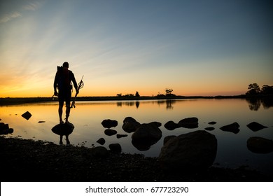 Spear Fishing At Sunrise. 