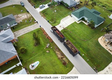 Special Aftermath Recovery Dump Truck Picking Up Vegetation Debris From Suburban Streets After Hurricane Ian Swept Through Florida. Dealing With Consequences Of Natural Disaster